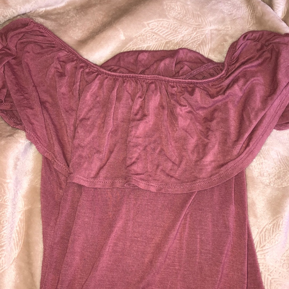 a mauve pink body suit